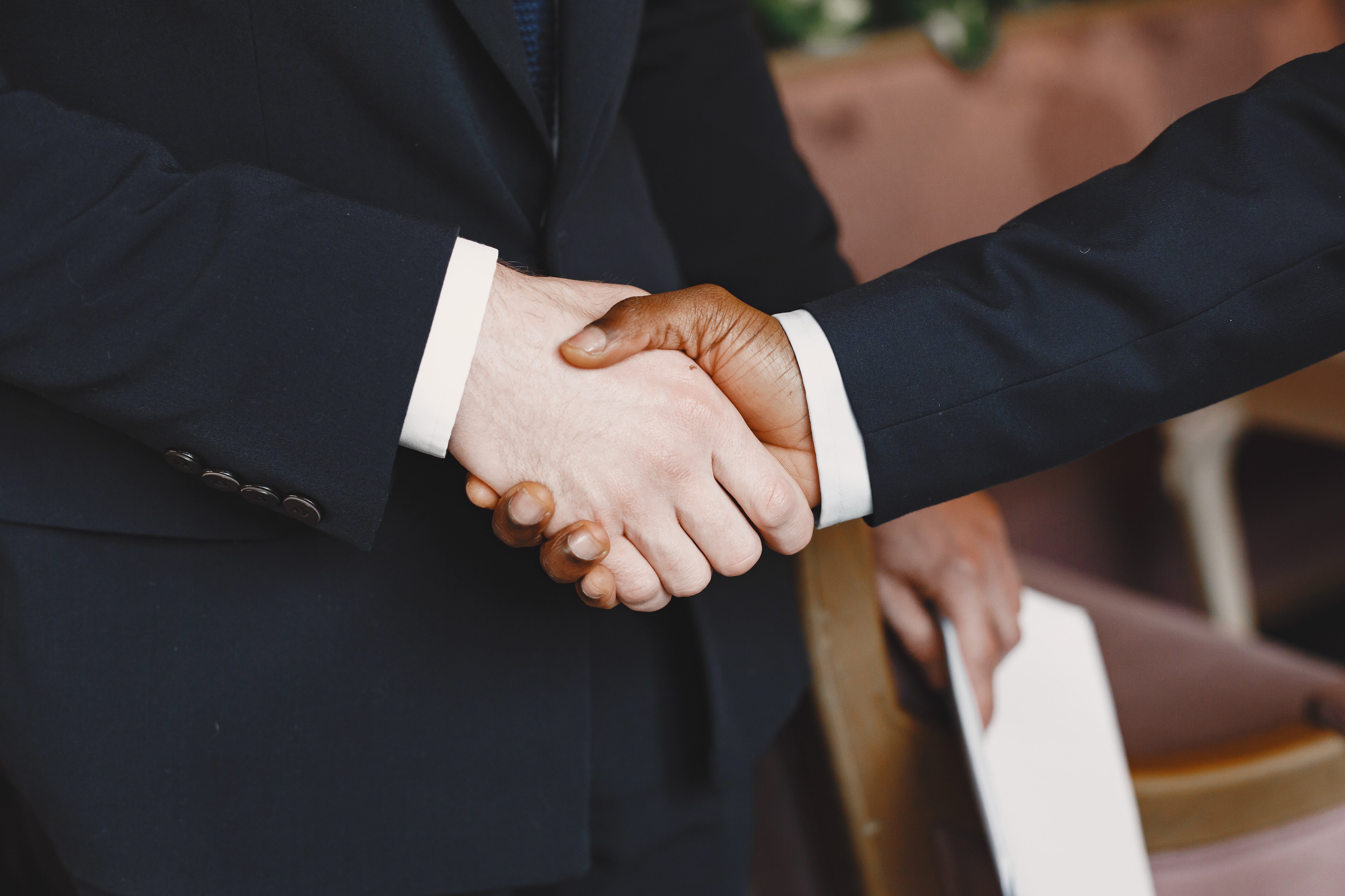 african-man-guy-black-suit-mixed-people-shake-hands